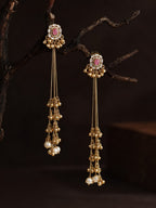 Gold earrings with gemstones and pearls on a dark background, Kashmiri Jhumka