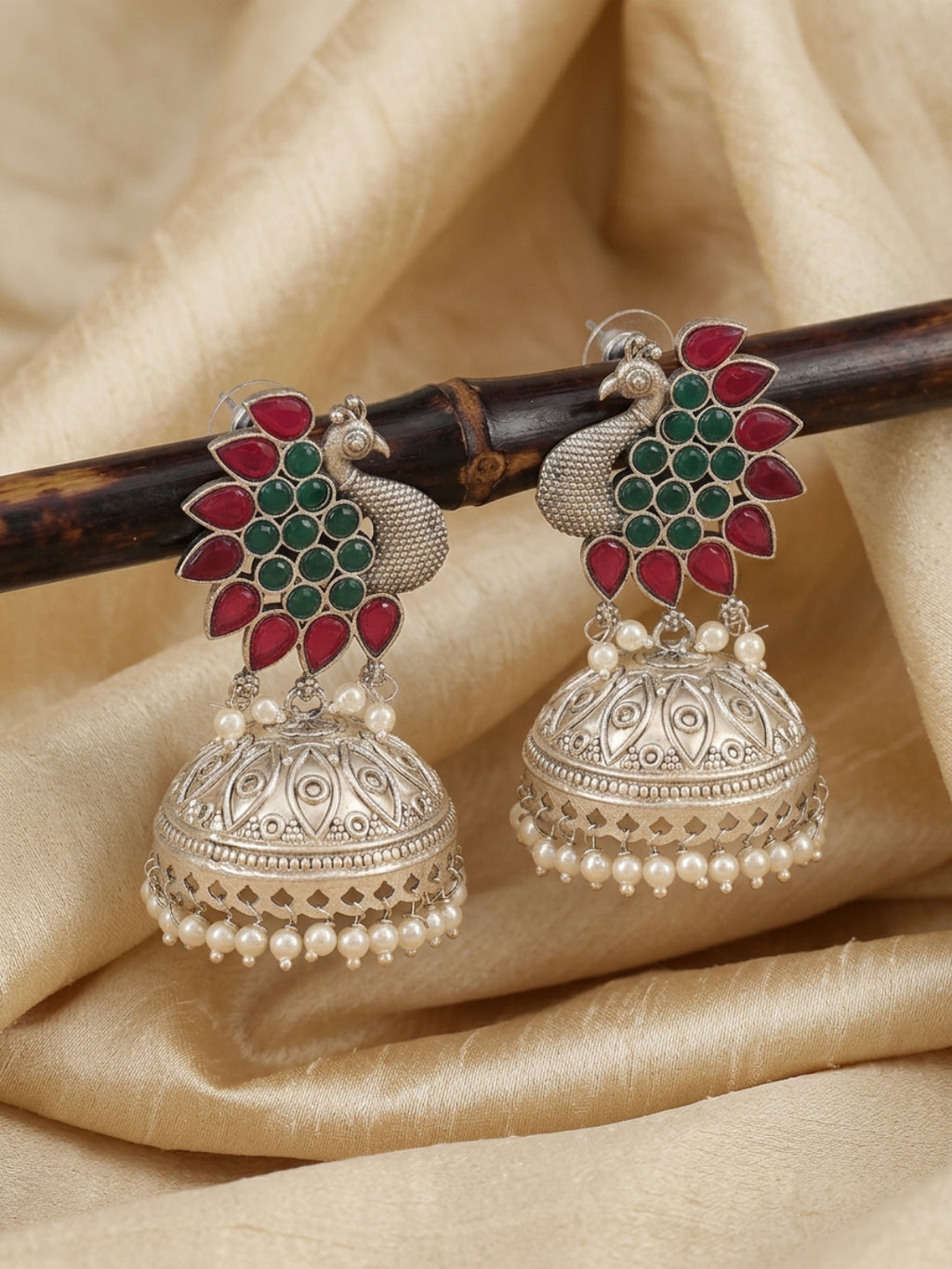 Peacock Jhumka Earrings — Red & Green Stone, Silver Finish