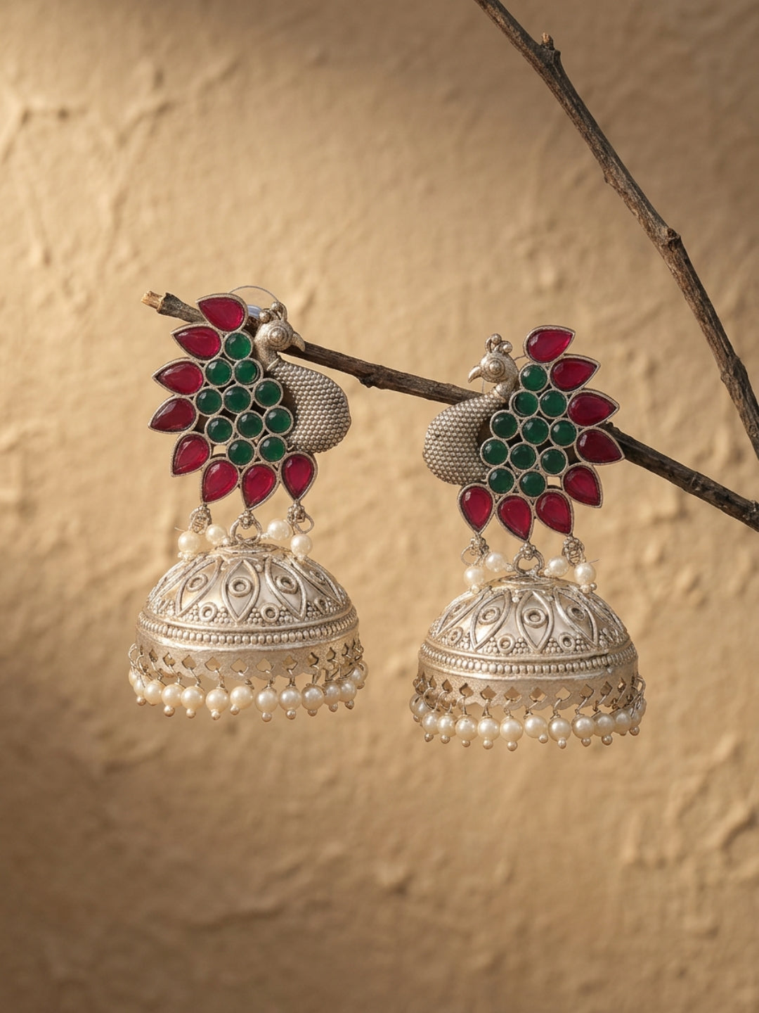 Peacock Jhumka Earrings — Red & Green Stone, Silver Finish